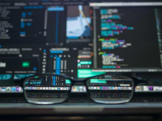 eyeglasses in front of computer screens