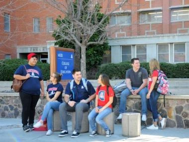 students sitting outside the college of education
